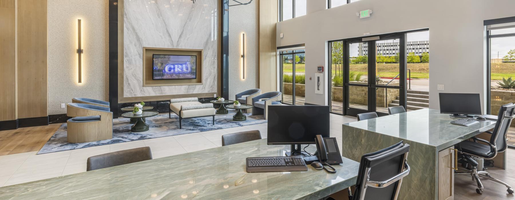 a room with a large glass wall and a large table with computers